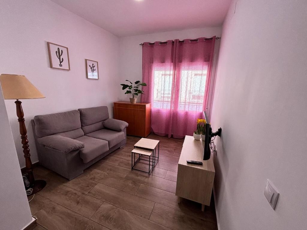 Living area with sofa and terrace window at ALOJAMIENTOS AGAVE